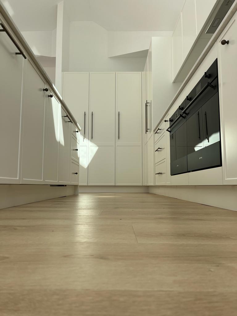 White L Shape Island Kitchen Galley View